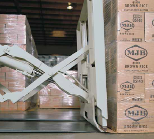 A close-up of a forklift clamping a pallet of boxes.